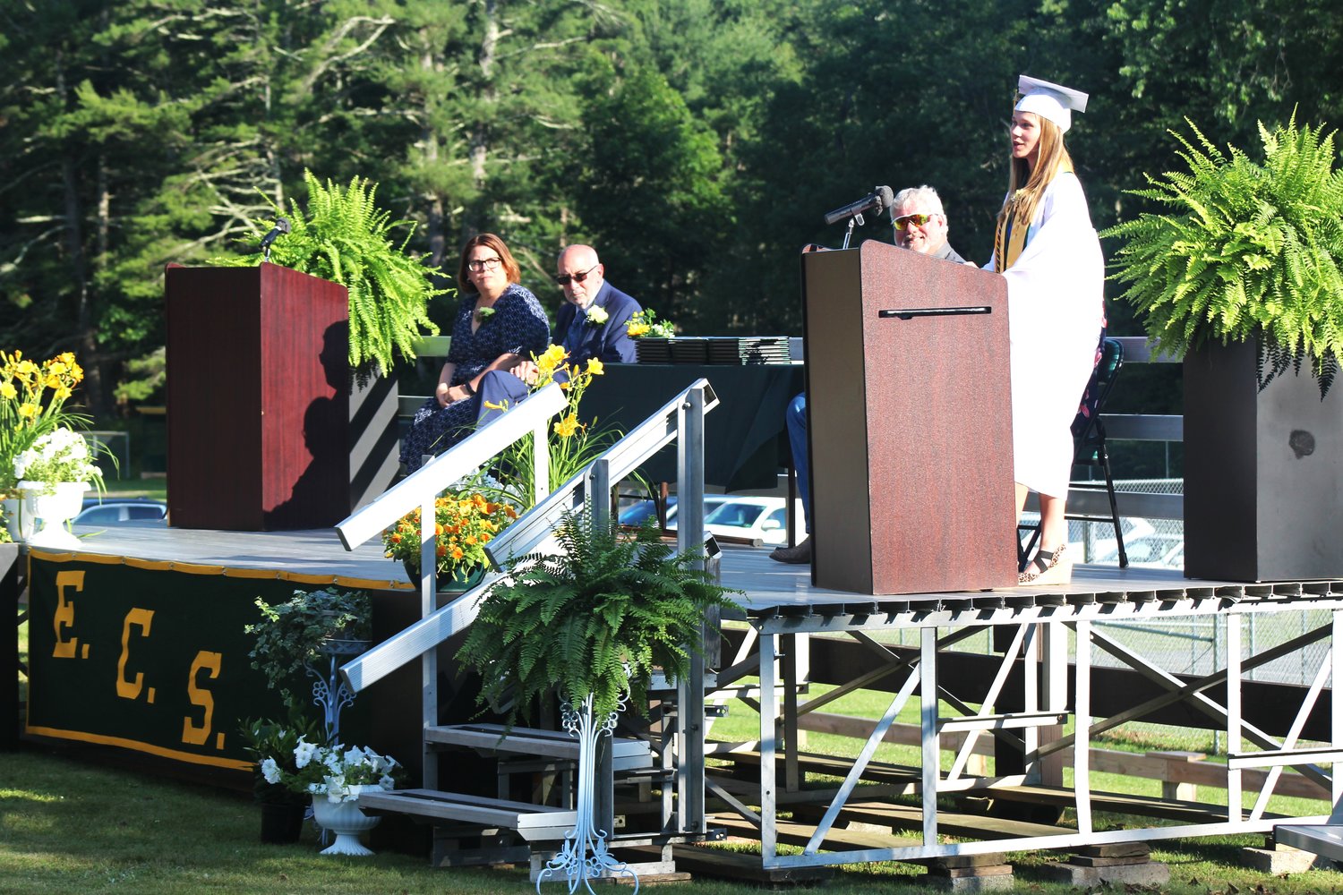 Valedictorian Kaitlyn Potter spoke of the benefits of being part of a small graduating class. Looking on are principal Tracy Ferreira, superintendent John Morgano, and school board president Scott Hallock.